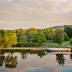 JOIGNY, FRANCE - SEPTEMBER 5: Boat on the Yonne river with reflections at sunset near Joigny on Septempber 5, 2020 in Burgundy, France.   License Type: media  Download Time: 2022-05-20T17:11:09.000Z  User: BBuckner_lonelyplanet  Is Editorial: Yes  purchase_order:   
