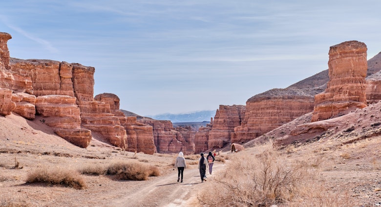 Almaty, Kazakhstan - March 19, 2024: National Nature Park Charyn Canyon in springtime. Valley of Castles. Natural monument, tourist landmark. People walking along road ., License Type: media, Download Time: 2025-07-04T09:50:19.000Z, User: clairenaylor, Editorial: true, purchase_order: 65050 - Digital Destinations and Articles, job: Online ed, client: Kazakhstan best things, other: Claire Naylor